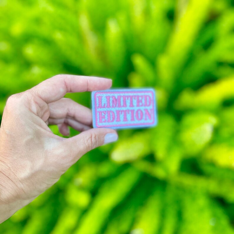 May include: A light blue fabric patch with pink lettering that reads "LIMITED EDITION".