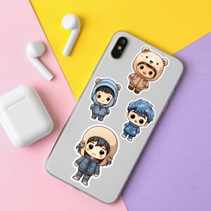 May include: A white phone case with four cartoon characters wearing winter clothing. The characters are wearing blue, brown, and white clothing. The phone case is on a pink and purple background.
