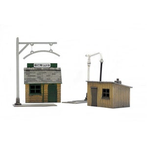 May include: A model railway set featuring a small, brown, wooden building with a green door and a sign that reads "Coal Office". There is a second, smaller building with a white roof and a grey door. The buildings are connected by a grey metal track.