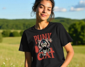May include: Black t-shirt featuring a graphic of a cat wearing a hoodie and the text "PUNK CAT" in red. The cat graphic includes a skull and crossbones. The shirt is worn by a person in a field.