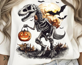May include: Cream-colored t-shirt featuring a Halloween-themed graphic. The design includes a skeletal T-Rex holding a jack-o'-lantern, with a full moon and bats in the background. The artwork is detailed with shades of orange, black, and gray.