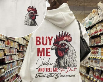 May include: White hoodie with a red rooster graphic and the text "Buy Me Chickens and Tell Me You Don't Trust The Government".