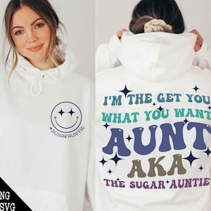 May include: White hoodie with a blue, green and brown graphic print that says "I'm the get you what you want aunt aka the sugar auntie".