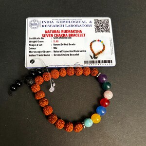 May include: A Seven Chakra bracelet with a mix of coloured round beads and brown Rudraksha beads. The bracelet is accompanied by a certificate from the India Gemological & Research Laboratory. The beads are of various sizes.