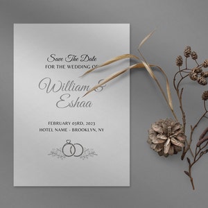 Puede incluir: Una tarjeta blanca de guardar la fecha con texto negro que anuncia la boda de William & Eshaa el 3 de febrero de 2023 en el Hotel Name en Brooklyn, NY. La tarjeta está decorada con una simple ilustración de dos anillos.