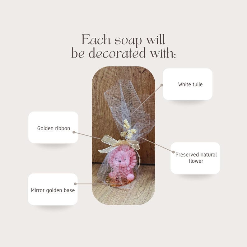 May include: A pink lion-shaped soap is wrapped in white tulle and tied with a golden ribbon. The soap sits on a mirror golden base and is decorated with a preserved natural flower. Text reads: Each soap will be decorated with: