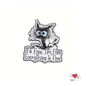 May include: A black and white enamel pin featuring a distressed cat with wide blue eyes. The pin has the text "It's Fine. I'm Fine. Everything Is Fine" in a stylized font, perfect for adding a touch of humor to any outfit.