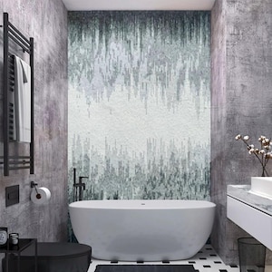 May include: Contemporary bathroom design featuring a white oval bathtub, black fittings, and a mosaic tile feature wall in grey and white tones. Includes a black towel rail, toilet, and monochrome tiled flooring.