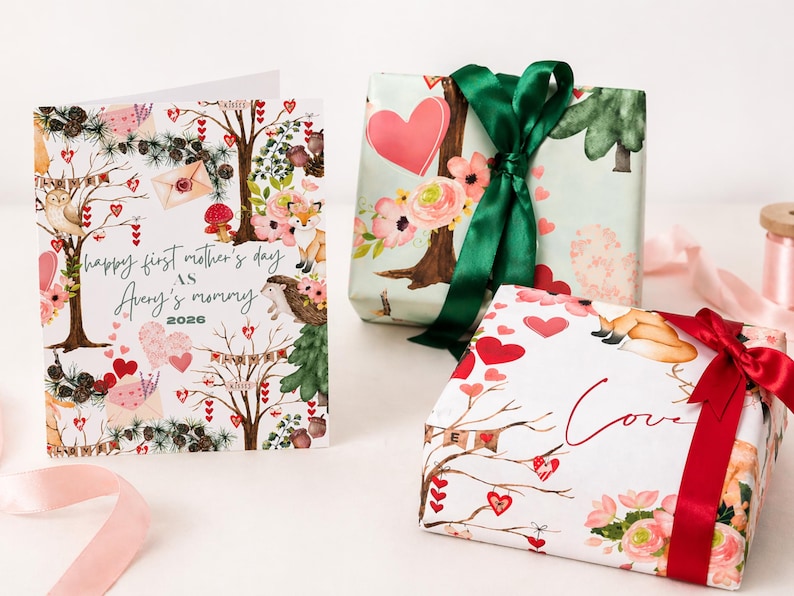 May include: A greeting card and two wrapped gifts. The card reads "Happy first mother's day as Avery's mommy 2026" with a woodland theme. The gifts are wrapped in floral and heart-themed paper, tied with green and red ribbons.