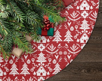 May include: Red and white Christmas tree skirt with a Scandinavian-inspired design featuring stylized trees, houses, and hearts. The skirt is decorated with a white snowflake pattern.