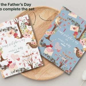 May include: Two Father's Day cards with floral and woodland illustrations. One card is white, the other is light blue. Both cards have the text "happy first father's day as amelia's daddy 2025".
