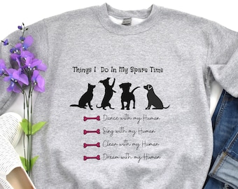 May include: Gray sweatshirt with the text "Things I Do In My Spare Time" and a line drawing of four dogs and a cat. The text below the drawing reads "Dance with my Human", "Sing with my Human", "Clean with my Human", and "Dream with my Human".