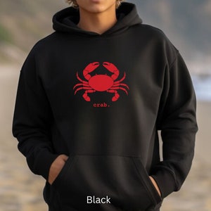 May include: Black hooded sweatshirt with a red crab graphic and the word "crab." printed below it.