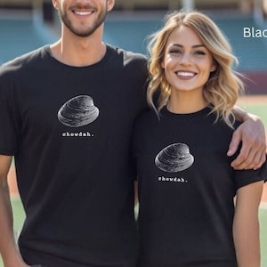 May include: Two black t-shirts with a white illustration of a clam and the text "chowdah."