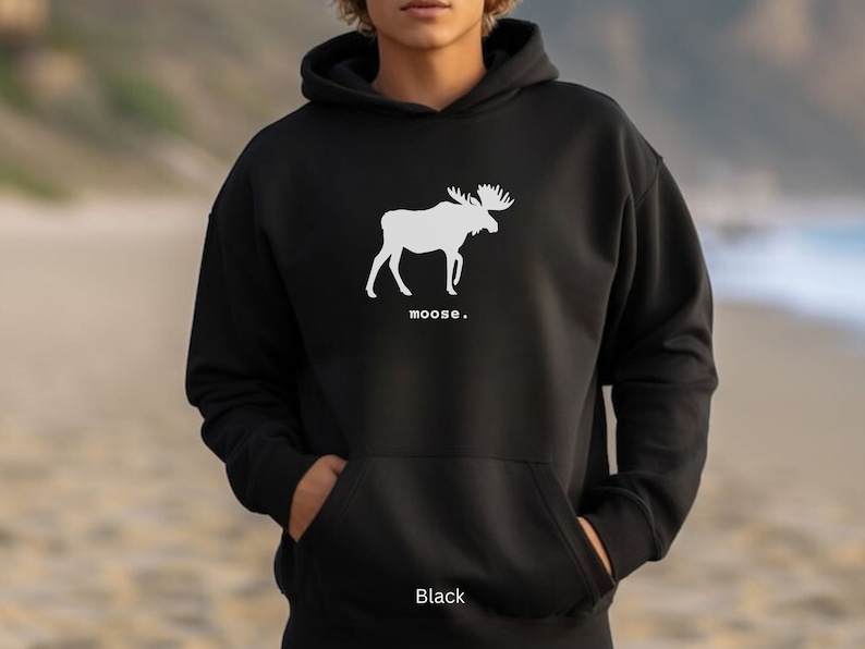 Adult unisex hooded sweatshirt with a graphic of a moose profile above the word moose in lower case font, followed by a period. Shown in Black.