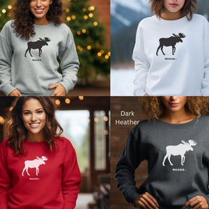 May include: Four different color sweatshirts with a moose silhouette graphic and the word "MOOSE." The sweatshirts are in the colors sport grey, white, red, and dark heather.