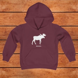 This youth hoodie features a white graphic of a moose with antlers facing to the right. The word moose is in lower case white font below the graphic, followed by a period.
