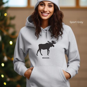 Adult unisex hooded sweatshirt with a graphic of a moose profile above the word moose in lower case font, followed by a period. Shown in Sport Grey.