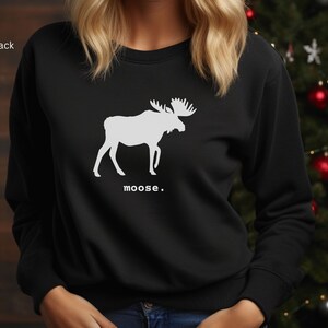 Adult unisex crewneck sweatshirt with a graphic of a moose profile above the word moose in lower case font, followed by a period. Shown in Black.