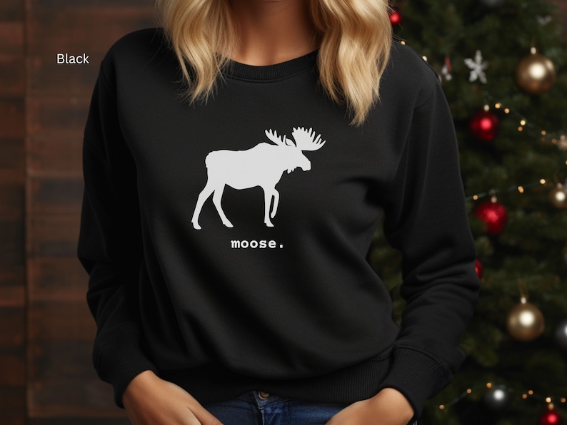 Adult unisex crewneck sweatshirt with a graphic of a moose profile above the word moose in lower case font, followed by a period. Shown in Black.