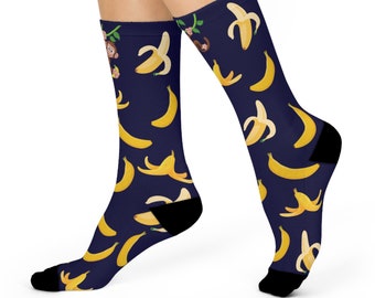 May include: A pair of blue socks with a pattern of yellow bananas and monkeys. The socks are made of a soft, comfortable material and are perfect for everyday wear.
