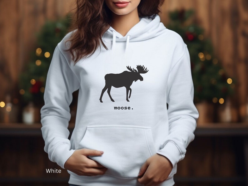 Adult unisex hooded sweatshirt with a graphic of a moose profile above the word moose in lower case font, followed by a period. Shown in White.