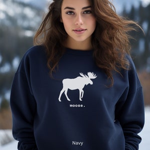 Adult unisex crewneck sweatshirt with a graphic of a moose profile above the word moose in lower case font, followed by a period. Shown in Navy.