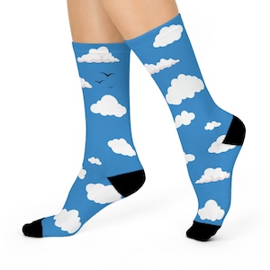 May include: A pair of blue socks with a white cloud pattern. The socks have black toes and heels.