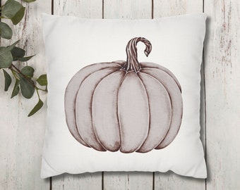 May include: A white throw pillow with a brown watercolor illustration of a pumpkin.