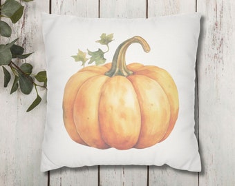 May include: A white pillow with a watercolor illustration of a single orange pumpkin with green leaves on the stem. The pumpkin is centered on the pillow.