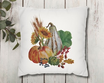 May include: A white pillow with a watercolor illustration of a pumpkin, gourd, sunflower, wheat, and berries. The illustration is in shades of orange, yellow, green, brown, and red.
