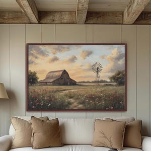 May include: A framed landscape painting depicts a rustic barn and windmill in a field of wildflowers under a cloudy sky. The artwork has a warm color palette with brown, green, and orange hues, evoking a sense of rural tranquility.