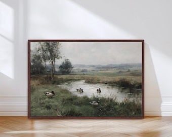 May include: A framed landscape painting depicts a serene pond scene with several ducks swimming and resting in the water and grassy banks. The artwork features a muted color palette with a brown frame.