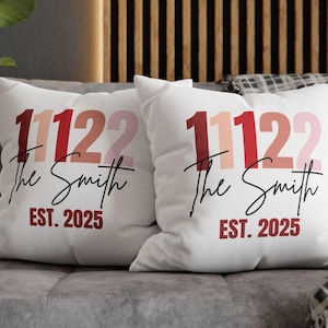May include: Two white throw pillows with the text "11122 The Smith EST. 2025" printed in red, pink and beige.