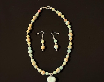 Aqua-colored Jasper beaded pendant necklace set. Heart-shaped pendant Jasper gemstone necklace. Matching silvery ear wire dangle earrings.