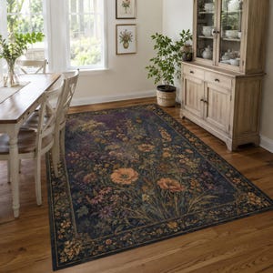 May include: A rectangular area rug featuring a dark navy blue background with a dense, colorful botanical print of orange poppies, yellow wildflowers, and green foliage, framed by a decorative border with repeating floral motifs.