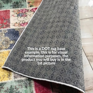 May include: A patchwork rug featuring a variety of colorful floral and ornate patterns in red, yellow, blue, and green. The underside of the rug is visible, showing a dark gray anti-slip backing with a repeating dot and diamond texture pattern.