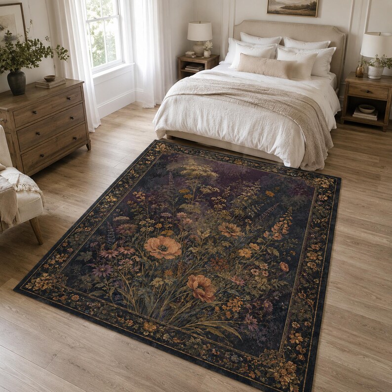 May include: A rectangular area rug featuring a dark, moody background with a dense, colorful botanical print of wildflowers, poppies, and foliage. The rug has a wide, decorative border filled with smaller floral motifs in shades of gold and brown.