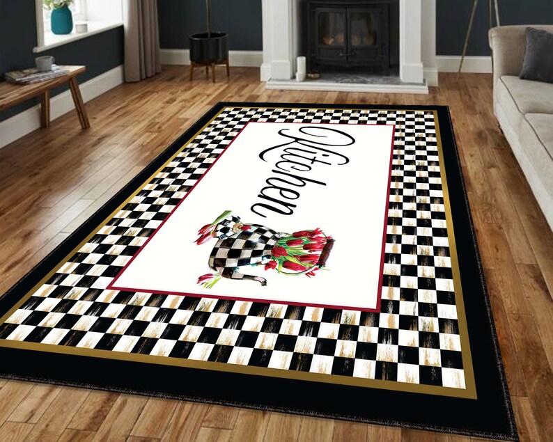 Black and white checkered kitchen rug with a gold border and a white center panel featuring the word "Kitchen" in black script and a black and white cow with red tulips.