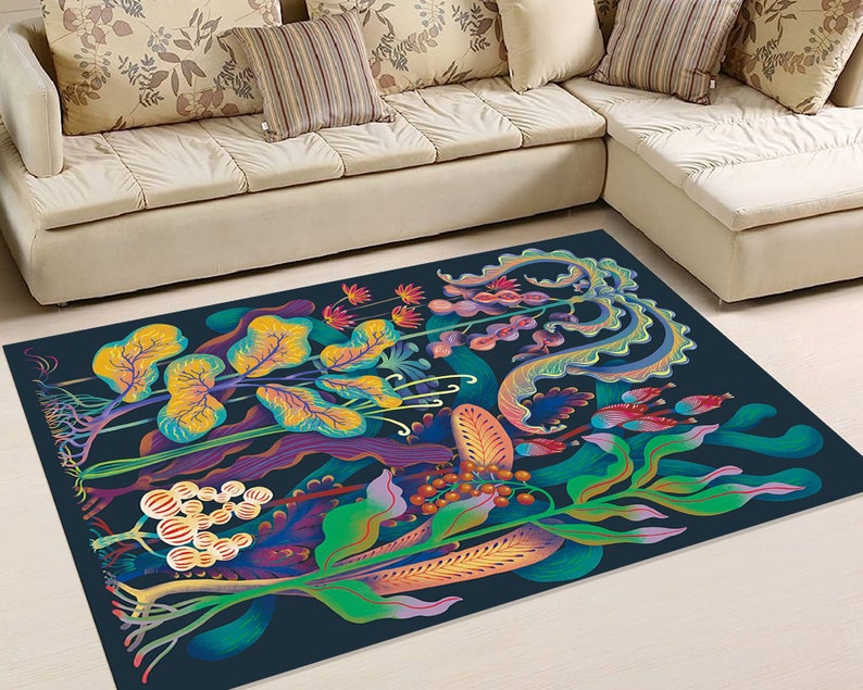 May include: A colorful rug with a dark blue background featuring a stylized floral design with yellow, green, blue, purple, and red flowers and leaves.