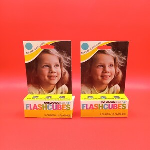 May include: Two packs of Sylvania Blue Dot Flashcubes for standard flashcube cameras. Each pack contains 3 cubes, providing 12 flashes.
