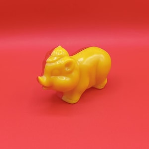 Vintage red and yellow plastic piggy bank