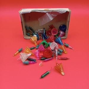 Vintage Christmas light covers for strand lights stored in vintage tissue box as found