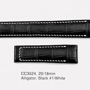Puede incluir: Una correa de reloj negra con un patrón de caimán texturizado y costuras blancas en contraste. La correa de dos piezas lleva el texto CC3524, 20/18mm, Alligator, Black #1/White, indicando el número de modelo y las dimensiones en milímetros.
