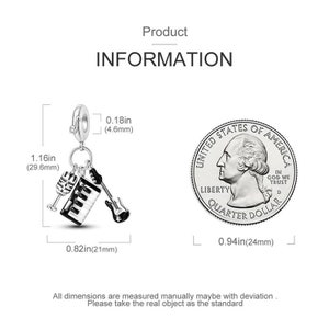 May include: Silver charm featuring a miniature keyboard, microphone, and guitar. The charm is 1.16 inches tall and 0.82 inches wide. It is attached to a silver chain with a lobster clasp.