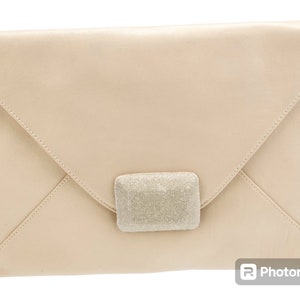 May include: A pale beige leather clutch with a silver sparkly clasp.