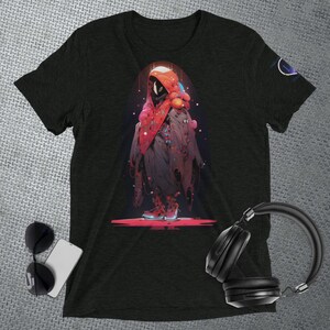 May include: A black t-shirt with a graphic print of a hooded figure in a red and black outfit with colorful accents. The figure is standing on a red platform.