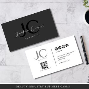 May include: Two business cards with a minimalist design. One is black with the name "Jackie Cooper, Hair Stylist" in white script. The other is white with a QR code and contact information, including social media icons.