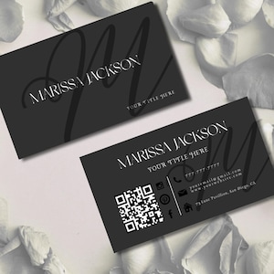 May include: Two black business cards with white text. The text on the card reads 'Marissa Jackson' and 'Your Title Here'. The card also includes a QR code, phone number, email address, website address, and physical address. The text 'Small Business Branding Kit' and 'Fully Editable in Canva with a Free Account' is displayed below the cards.