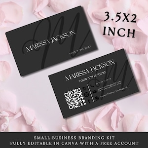 May include: Two black and white business cards with the name Marissa Jackson and the text 'Your Title Here'. The cards also include a QR code, phone number, email address, website address, and physical address. The text '3.5x2 inch' is displayed above the cards. The cards are on a background of pink flower petals.